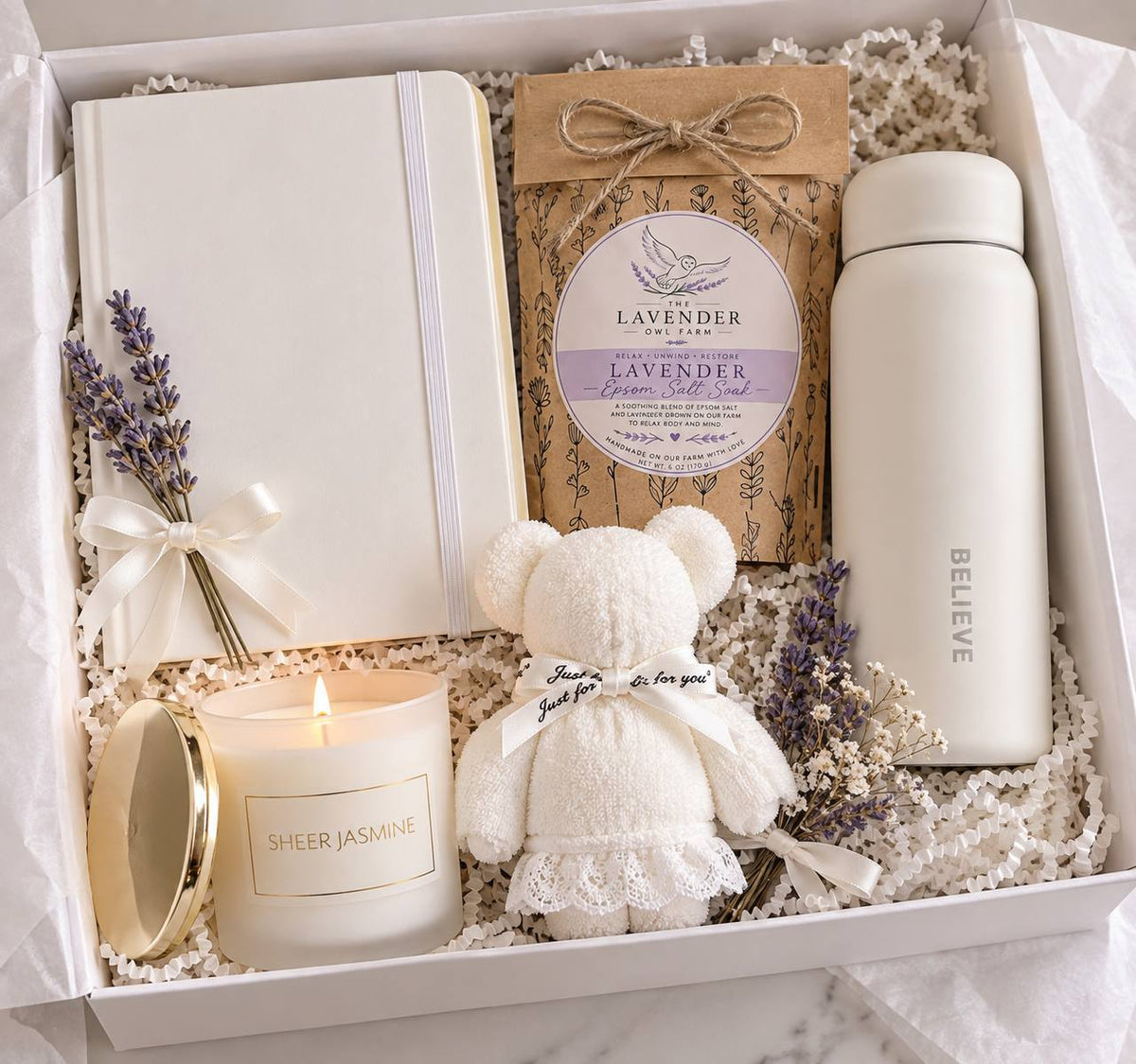 ALILUNE Lavender Cozy Gift Box with a cream journal, white drink bottle, lavender bath soak, jasmine candle and teddy bear